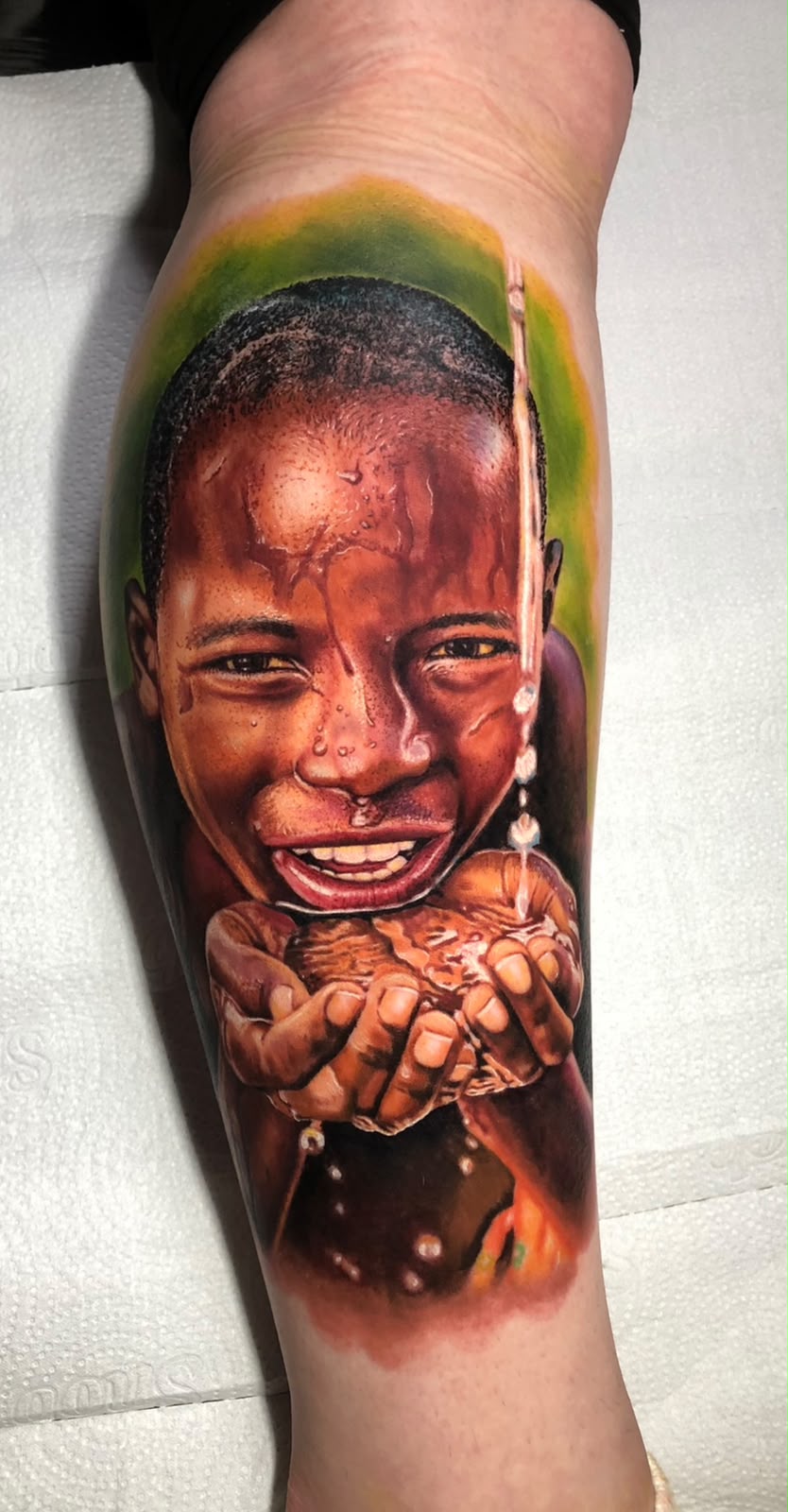 Tatuagem Realismo Colorido Água nas Mãos na região panturrilha feita por Bagé em Porto Alegre