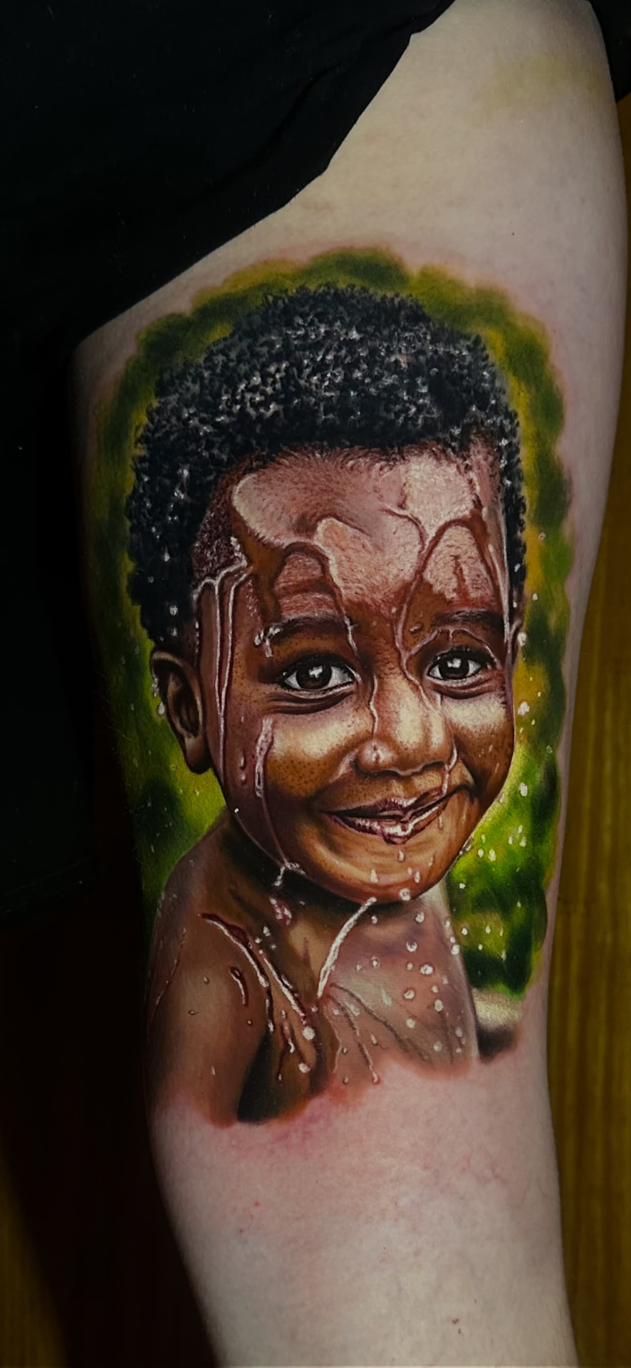 Tatuagem Realismo Colorido Menino na Água na região braço feita por Bagé em Porto Alegre